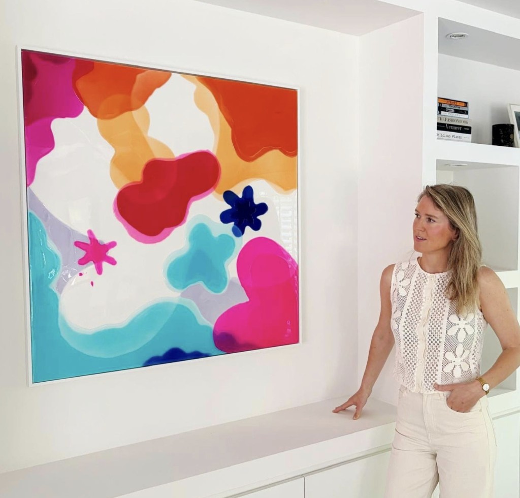 Belgian abstract-pop artist Barbara Cox beside one of her colourful paintings at Never Give Up Gallery