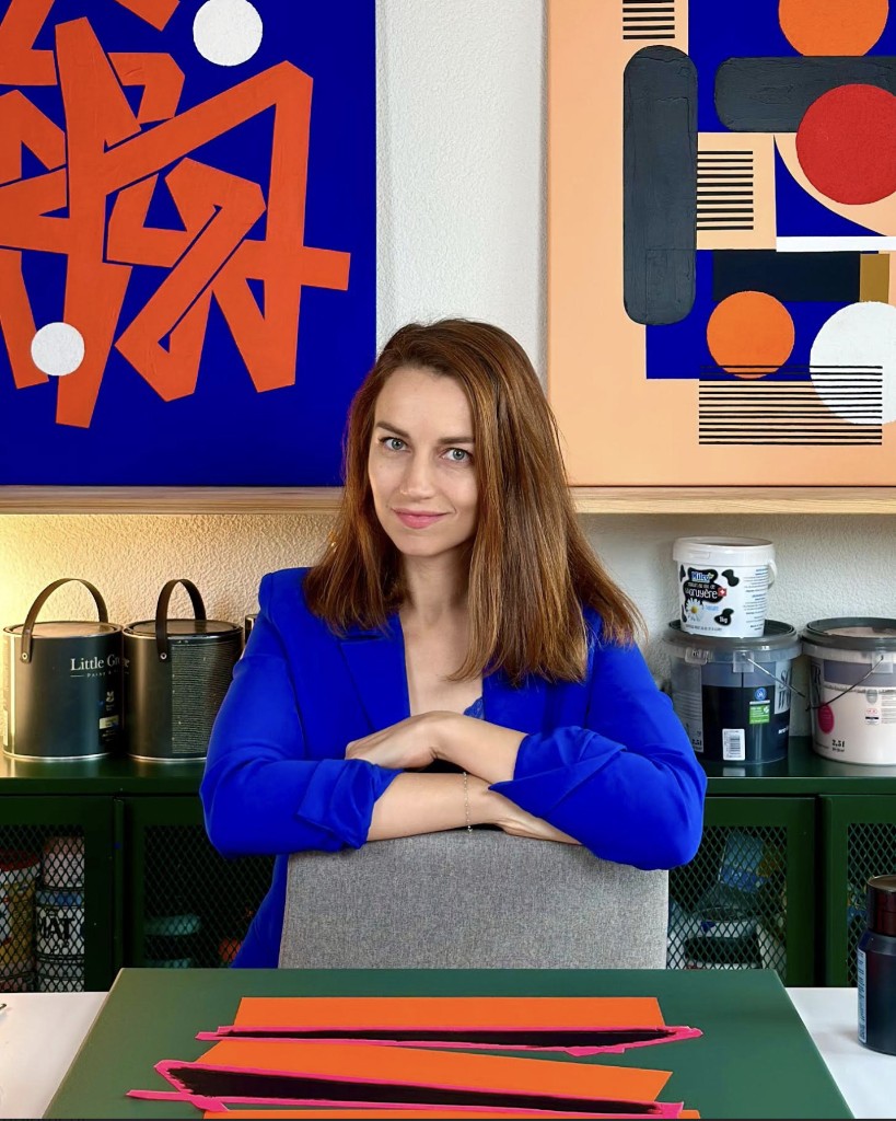 Swiss visual artist Elena Braye (Murotopia) in her studio with bold geometric abstract paintings