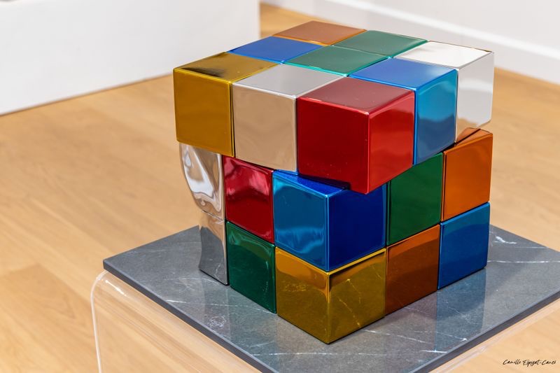 Philippe Gauberti — polished inox Rubik's Cube sculpture on acrylic pedestal